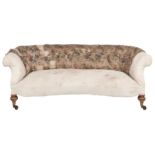 A Victorian Chesterfield sofa, with serpentine front, on bulbous walnut feet, brass castors, seat