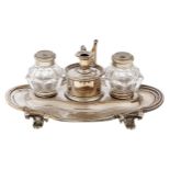 A Victorian EPNS inkstand, with pair of glass inkwells and taperstick and extinguisher, engraved