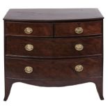 A George III bow fronted mahogany chest of drawers, the drawers oak lined, on splayed feet, 85cm