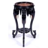 A French carved and ebonised wood stand, late 19th c, the circular top marble inset top on three