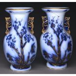 A pair of Staffordshire gilt flow blue earthenware 'Chinese' vases, c1870, moulded to either side in