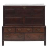 A George II oak mule chest, the upper part with five raised and fielded panels to the front, the