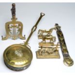 An early Victorian pierced brass lyre shaped trivet, on iron legs with turned wood handle, 28cm l,