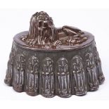 A stamped brass and tinplate jelly mould in the form of a lion, late 19th / early 20th c, 20cm l A