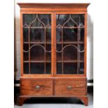 A George III mahogany bookcase, with stepped cavetto cornice and fitted with adjustable shelves
