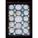 Thirty five plaster casts of medals and gems, antique subjects, various sizes, in mahogany frame, 35