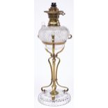 An Edwardian art nouveau brass and cut glass oil lamp, the pyramid cut fount with stopper and