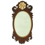 A parcel gilt walnut fretted frame mirror, 19th / early 20th c, with oval plate, 75cm h Mirror