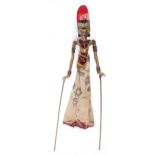 A Javanese polychrome wood and sequin decorated cloth shadow puppet,  approx 66cm Complete with