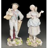 A pair of German porcelain figures of a grape harvester and girl with puppy or kitten, late 19th