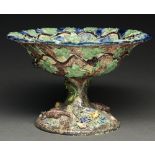 A French Palissy ware footed bowl, late 19th c,  applied with reptiles, shells and foliage encircled