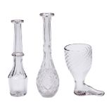 An English wrythen fluted glass boot novelty stirrup cup and two contemporary flat or faceted