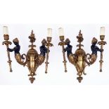 A pair of gilt lacquered and black patinaed cast brass twin demi figural wall lights, second quarter
