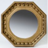 An octagonal giltwood convex mirror, 19th c, with reeded slip in ribbon-and-reed cavetto frame