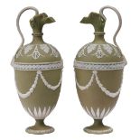 A pair of Wedgwood green Jasper ewers, late 19th c, ornamented with festoons and satyr masks, 23cm