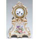 A French porcelain mantel clock, c1840, with bell striking movement and enamel dial, in richly