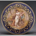 A Vienna style plate, c1900, painted by Hauser, signed, with a maiden and playful putto in a