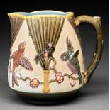 A Wedgwood majolica jug, c1875, moulded with birds on prunus between Japanese fans, the interior