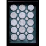 Twenty three plaster casts of medals and gems, antique subjects, various sizes, in mahogany frame,