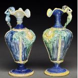 A pair of French Palissy ware ewers, late 19th c, of pear shape with mermaid handle and moulded
