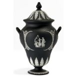 A Wedgwood black jasper dip vase and cover, c1900, sprigged with neo classical ornament, 30cm h,