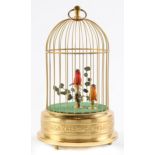 A Swiss clockwork singing bird in a cage automaton, late 20th c ,  the cage of lacquered brass, 25cm