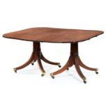 A George III twin-pillar mahogany dining table, the finely figured top on ring turned 'gun barrel'