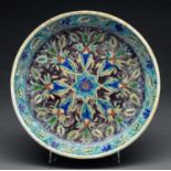 An Armenian pottery dish, Palestine, early 20th c, painted in a typical palette with stylised