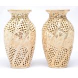A pair of Fischer reticulated vases, c1900, shouldered oviform and of spiral design with central