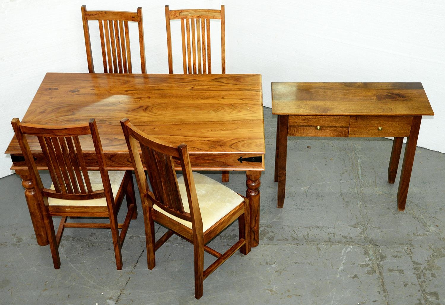 A South East Asian hardwood dining table,   on turned legs and a set of four chairs, seat height
