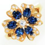A flower shaped sapphire and diamond cluster ring, in 18ct gold, import marked, London 1988, 5g,