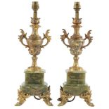 A pair of giltmetal mounted and onyx table lamps, late 19th / early 20th c, of two handled rococo