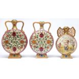 One and a pair of Fischer Moon flasks, late 19th c, decorated with a girl and musicians or flowers