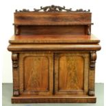 A Victorian carved mahogany chiffonier, the lower part enclosed by panelled doors and fitted with