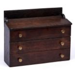 An English boarded oak candle box, 19th / 20th c, with sloping lid and two drawers, they and the