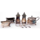 A pair of Elizabeth II silver salt cellars and baluster pepperettes, with gadrooned rim and paw