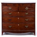 A Victorian bow fronted mahogany chest of drawers, the crossbanded top above a figured frieze