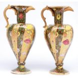 A pair of Fischer gilt and crimson ground ewers, late 19th c, decorated with alternating wide and