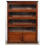 An Edwardian mahogany bookcase, the moulded cornice above four glazed up-and-over doors, the lower