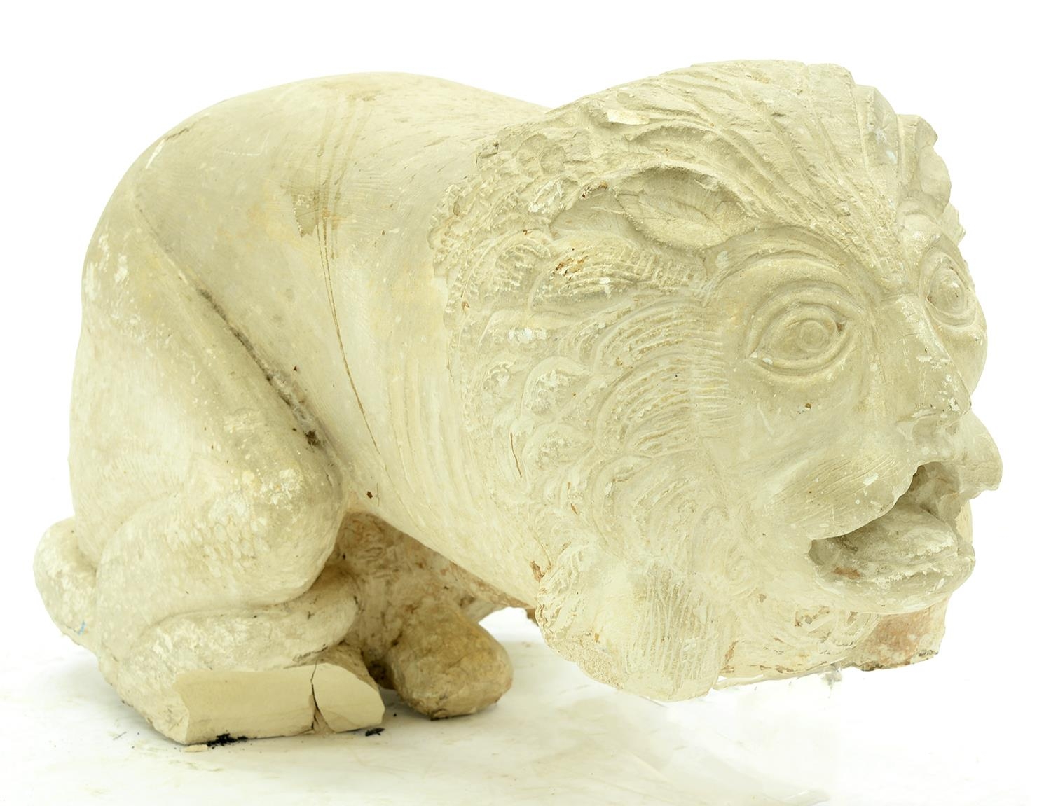 A South East Asian carved stone model of a recumbent lion, 20th c, approximately 57cm l Good