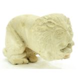 A South East Asian carved stone model of a recumbent lion, 20th c, approximately 57cm l Good