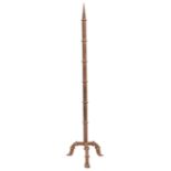 An iron pricket stick, of square form with collars, on conforming tri-form base, 124cm h Good,