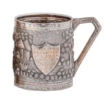 An Indian silver repousse mug, Calcutta, c1900, decorated with a continuous village scene, the plain