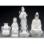 A Chinese Blanc de Chine figure of Guanyin, two others and a vase, 20th c, 31cm h and smaller Good