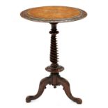 A Victorian burr walnut  tripod table, c1865, the round top with figured panel within foliate carved