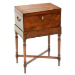 A George III mahogany teapoy, the affixed line inlaid stand on ring turned legs, crossed stretchers,