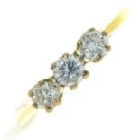 A three stone diamond ring, in gold, indistinctly marked, 2.9g, size J½ Good condition