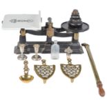 A set of brass mounted iron grocer's scales, a pair of Victorian brass trivets, a brass garden