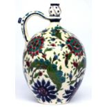 A Zsolnay flask, late 19th c, with pinched neck and spouted handle, with Iznik style floral