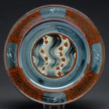Studio pottery. David Frith (1943 - ) - Stoneware charger, in tenmoku and other glazes with